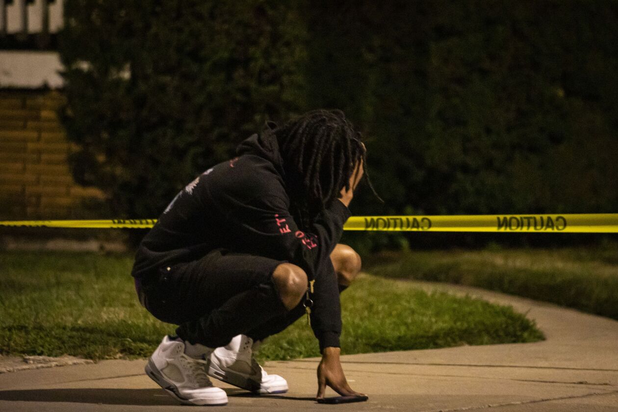 A man reacts at the scene after a 22-year-old man was shot in the face early Monday in a backyard in the 9500 block of South Yale Avenue in Longwood Manor on the South Side.